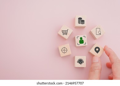 senior businessman's hand hold check in icon on wooden cube block people inside crop in middle for buyer persona and target customer concept, buyer or customer psychology profile or characteristics