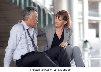 Senior businesswoman empathy with businessman during counseling and encourage in modern office, problem with business of business man with stress for financial while business woman encourage. - Powered by Shutterstock