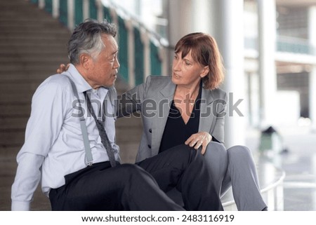 Senior businesswoman empathy with businessman during counseling and encourage in modern office, problem with business of business man with stress for financial while business woman encourage.