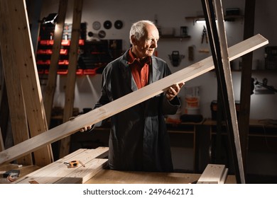 Senior carpenter inspecting a wooden plank in his workshop, carefully examining the wood quality for his next project - Powered by Shutterstock