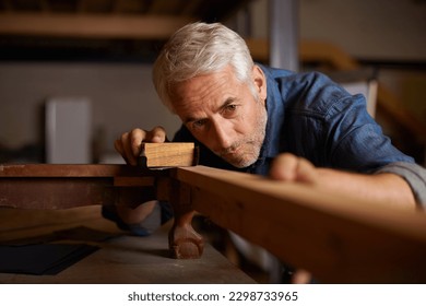 Senior carpenter, wood sanding and man with precision on building construction and architecture project. Home improvement, handyman and work of a mature male employee with carpentry tool for woodwork - Powered by Shutterstock