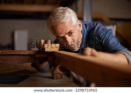 Senior carpenter, wood sanding and man with precision on building construction and architecture project. Home improvement, handyman and work of a mature male employee with carpentry tool for woodwork