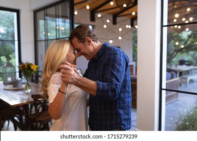 Senior Caucasian couple enjoying their time at home together, dancing in a kitchen and smiling, social distancing and self isolation in quarantine lockdown during coronavirus covid19 epidemic - Powered by Shutterstock