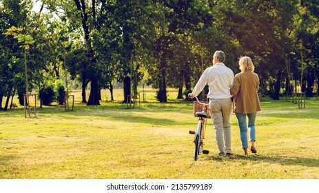 Senior Caucasian couple hugging in park. Family with a happy smile feels relaxed with nature in the morning. Or in the evening. Enter elderly society And retire from work. Concept health insurance - Shutterstock ID 2135799189