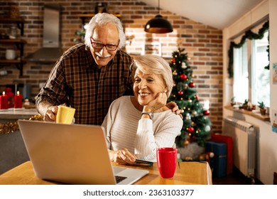 Senior Caucasian couple online shopping for presents for their grandchildren at home during christmas and the new year holidays - Powered by Shutterstock