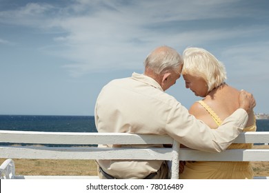 senior caucasian couple sitting on bench near the sea and hugging. Horizontal shape, rear view, copy space - Powered by Shutterstock