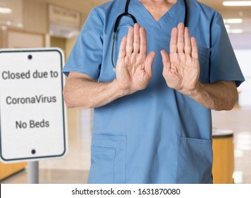 Senior caucasian doctor in scrubs in hospital stopping entry because no beds available because of coronavirus or flu - Shutterstock ID 1631870080