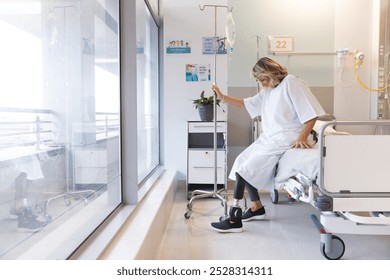 Senior caucasian female patient with prosthetic leg sitting on bed at hospital, copy space. Hospital, disability, medicine and healthcare, unaltered. - Powered by Shutterstock