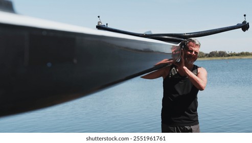 Senior caucasian man carrying a rowing boat. sport retirement leisure hobbies rowing healthy outdoor lifestyle. - Powered by Shutterstock