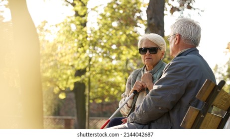 Senior Caucasian Man With His Disabled Blind Wife In The Park Handicapped People Support Concept Portrait Copy Space Selective Focus . High Quality Photo