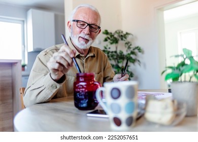 Senior Caucasian man painting at her home.  - Powered by Shutterstock