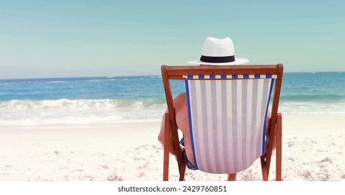 Senior Caucasian man relaxes on a beach chair, with copy space. His tranquil moment captures the essence of a serene beachside retreat. - Powered by Shutterstock