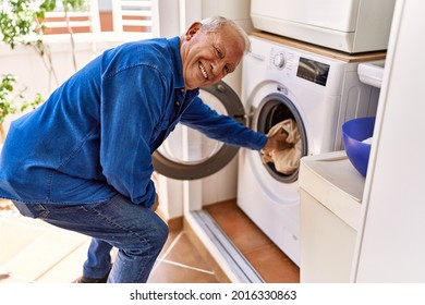 Senior caucasian man smiling happy doing laundry at the terrace. - Powered by Shutterstock