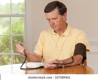 Senior Caucasian Retired Male Taking Blood Pressure At Home