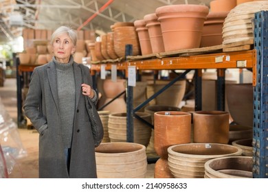 Senior Caucasian Woman Shopping In Earthenware Crockery Store.