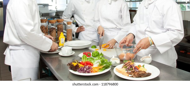 A Senior Chef Giving Cooking Lesson To Young Chefs