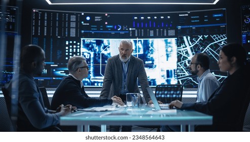 Senior Chief Software Engineer Showing a Satellite Tracking Technology Capabilities to a Group of High Profile Government and Cybersecurity Officials. Colleagues Discussing New GPS Software - Powered by Shutterstock