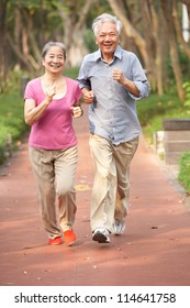 Senior Chinese Couple Jogging In Park