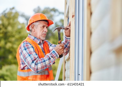 Senior Citizen As Building Construction Craftsman Working On New House