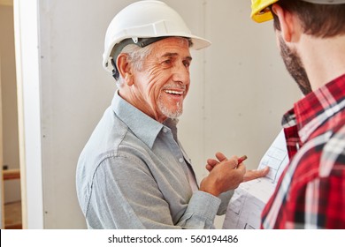 Senior Citizen As Craftsman With Experience Cooperating With Foreman