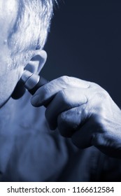 Senior Citizen Man Cutting Inner Ear Hair With Electric Cutter.