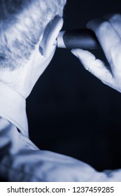 Senior Citizen Man Cutting Inner Ear Hair With Electric Cutter.