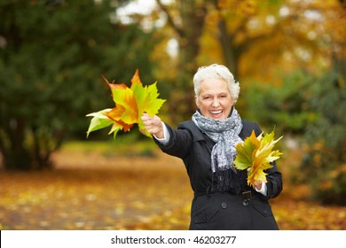 Senior Citizen Strolling In A Park In Autumn