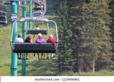 Senior Citizen Women Elderly On A Chair Lift In The Summer At Lake Louise, Banff Canada