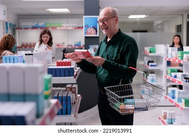 Senior Client Looking At Drugs Package During Medication Shopping In Pharmacy. Old Customer Reading Cardiology Pills Leaflet, Buying Pharmaceutical Treatment To Cure Disease. Health Care Support