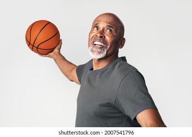 Senior Coach Holding A Basketball