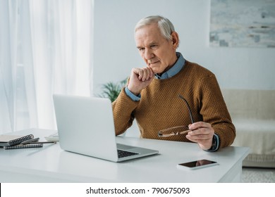 Senior Confident Man Working On Laptop