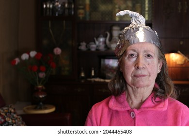 Senior conspiracy theorist wearing weird hat