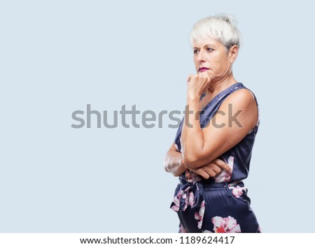 senior cool woman with a goofy, dumb, silly look, feeling shocked and confused at a recent realization, not really understanding an idea.