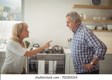 Senior couple arguing in kitchen at home - Powered by Shutterstock