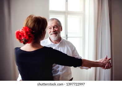 Senior Couple Attending Dancing Class In Community Center.