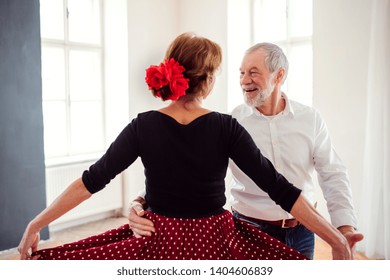 Senior Couple Attending Dancing Class In Community Center.