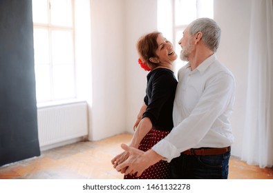 Senior Couple Attending Dancing Class In Community Center.