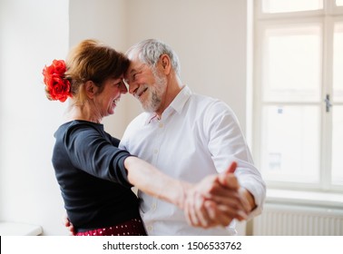 Senior Couple Attending Dancing Class In Community Center.