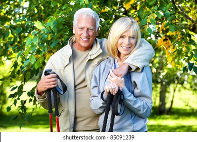 Senior Couple With Backpacks And Trekking Poles. Adventure.