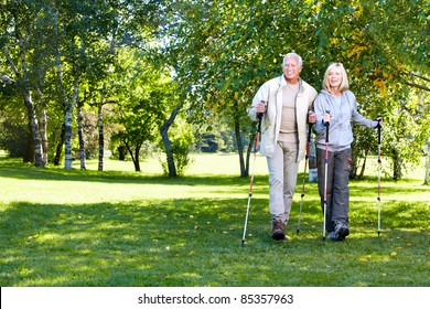 Senior Couple With Backpacks And Trekking Poles. Adventure.