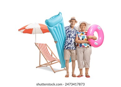 Senior couple at the beach with an air mattress and a swimming tire isolated on white background - Powered by Shutterstock