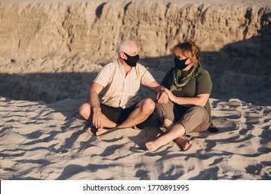 Senior couple in the beach wearing medical mask to protect from coronavirus in summer day, coronavirus quarantine - Powered by Shutterstock