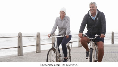 Senior couple, bicycle and happy on promenade, beach and outdoor in morning with exercise in summer. Man, woman and cycling with smile by sea, ocean and journey for workout with bonding in England - Powered by Shutterstock