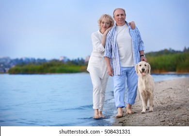 Senior couple and big dog on riverside - Powered by Shutterstock