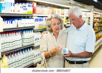 Senior Couple Buying Milk At The Supermarket