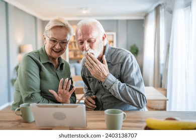 Senior couple caucasian old man and woman husband and wife pensioner grandfather and grandmother use digital tablet for online video call at home in bright room real people family concept copy space - Powered by Shutterstock