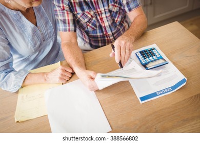 Senior Couple Checking Their Bills At Home