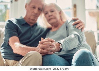 Senior couple, compassion and support with holding hands, assistance or grief in nursing home or retirement. Elderly people, hug and wellness as empathy in living room for love, care or communication - Powered by Shutterstock