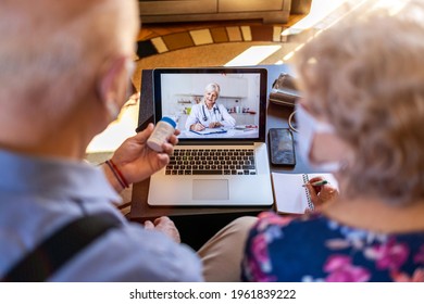 Senior Couple Consulting With A Doctor On Laptop At Home