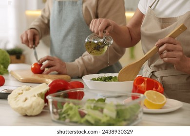 Senior couple cooking together in kitchen, closeup - Powered by Shutterstock